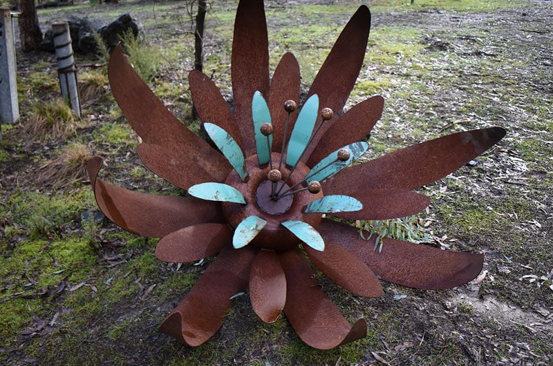 Aqua and rust scrap metal sculpture flower, Tread Sculptures