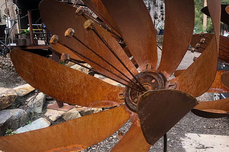 Rust sculpture flower on stem, Tread Sculptures, Melbourne
