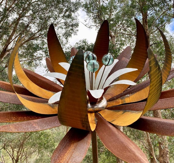 Scrap metal flower with triple layers and Japanese glass fishing float stamens handmade by Tread Sculptures in Melbourne, Australia