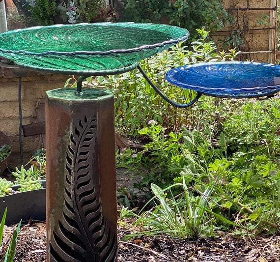 Recycled glass birdbaths available in green and blue colours handmade by Tread Sculptures in Melbourne, Australia