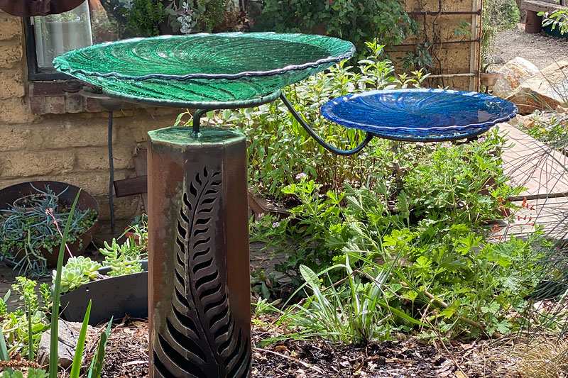 Recycled glass birdbaths available in green and blue colours handmade by Tread Sculptures in Melbourne, Australia