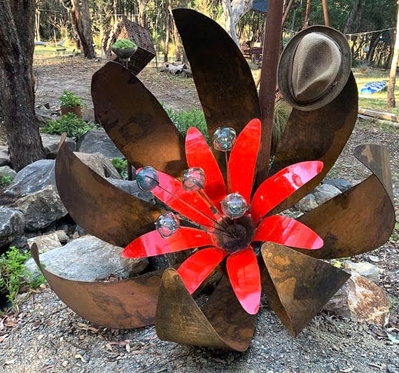 Red ground flower made of scrap metal and recycled materials by Tread Sculptures in Melbourne, Australia