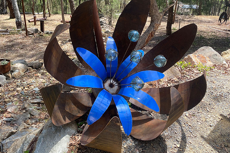 Huge blue flower sculpture made of scrap metals by Tread Sculptures in Melbourne, Australia