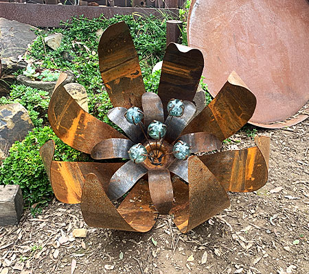 Huge scrap metal flower sculpture made from recycled materials in Melbourne, Australia