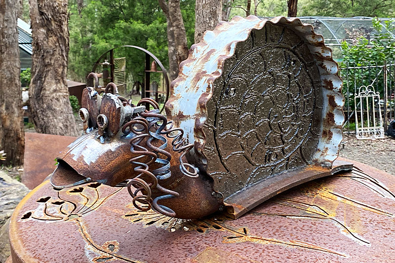 Rusty snail sculpture made from reclaimed steel by Tread Sculptures