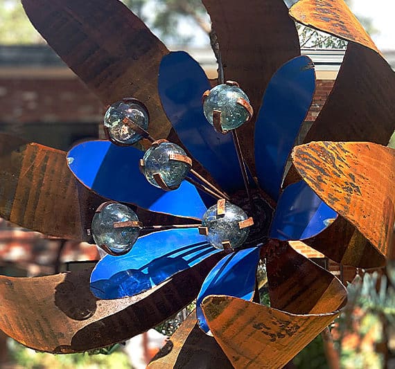 Rusty metal flower sculpture made from recycled materials by Tread Sculptures