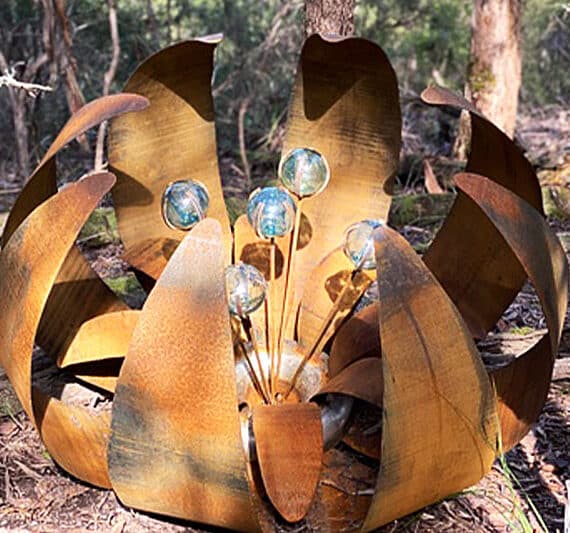 Rusty reclaimed metal ground flower made from recycled materials by Tread Sculptures