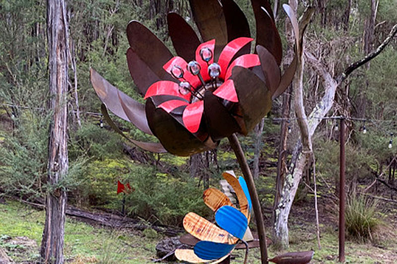 Rusty metal ground flower made from reclaimed materials by Tread Sculptures