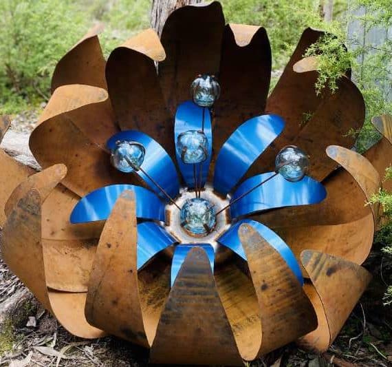 Huge blue rusty ground flower made from recycled materials