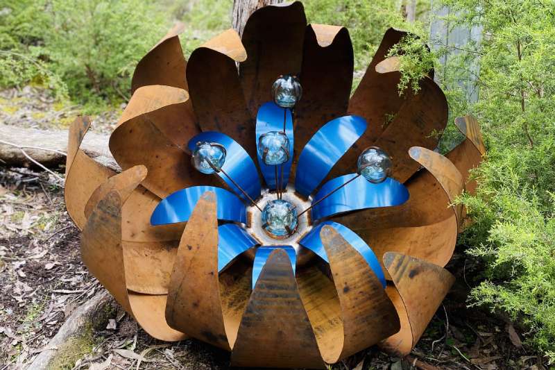 Huge blue rusty ground flower made from recycled materials