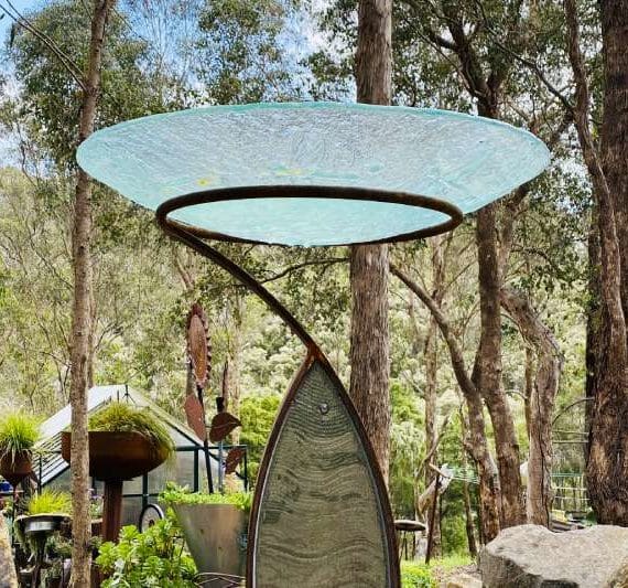 Glass birdbath sculpture made from reclaimed materials