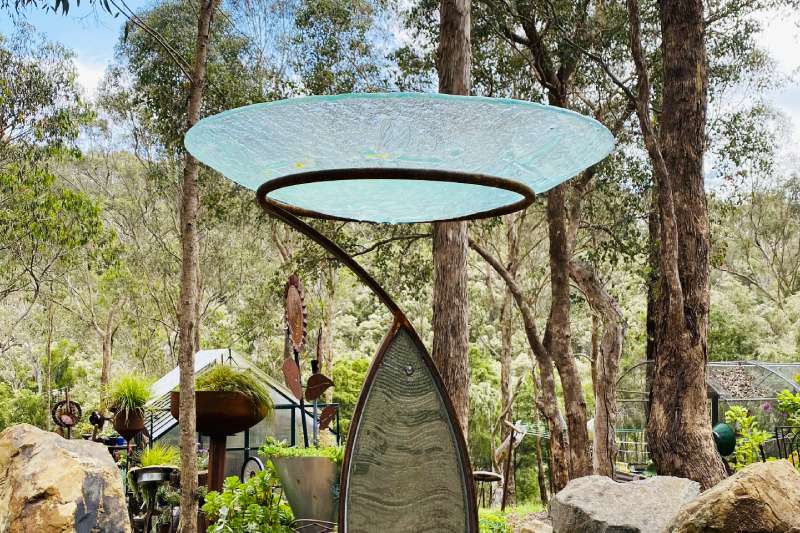 Glass birdbath sculpture made from reclaimed materials