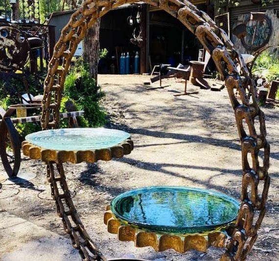 Scrap metal birdbath made from reclaimed excavator truck chain