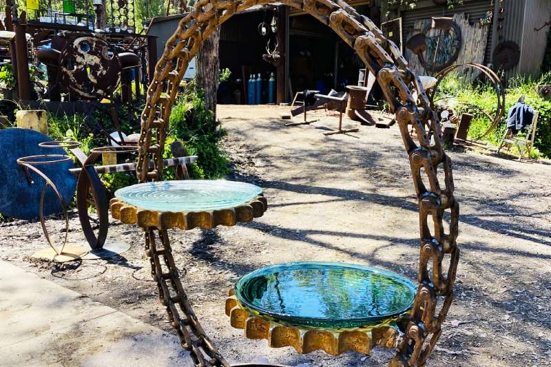 Scrap metal birdbath made from reclaimed excavator truck chain