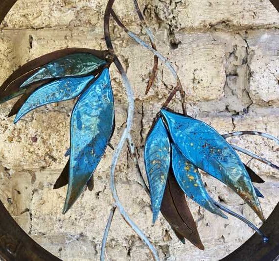 The glaze is mixed and hand-painted to make each leaf unique. The glass is then fired in the kiln to slump it and bake on the glaze before the whole piece assembled.