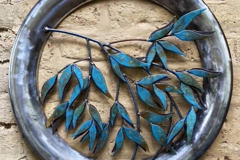 Silver Gums is set inside a reclaimed stainless steel frame with mild steel leaves plasma cut by hand to form the base for the glass.