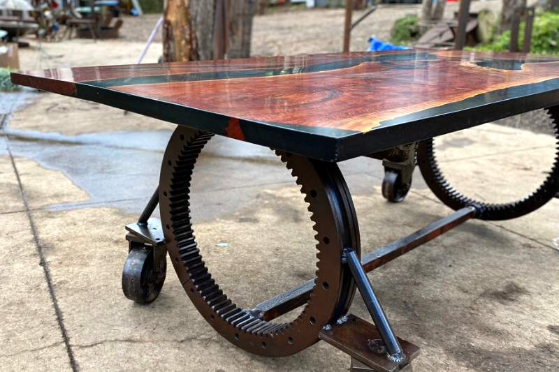 A steam punk table crafted from recycled materials, featuring unique gears and metallic accents, adding character and industrial charm to any space.