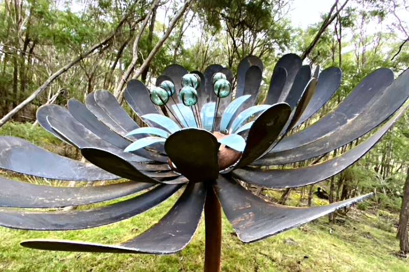 Rusty metal ground flower made from reclaimed materials