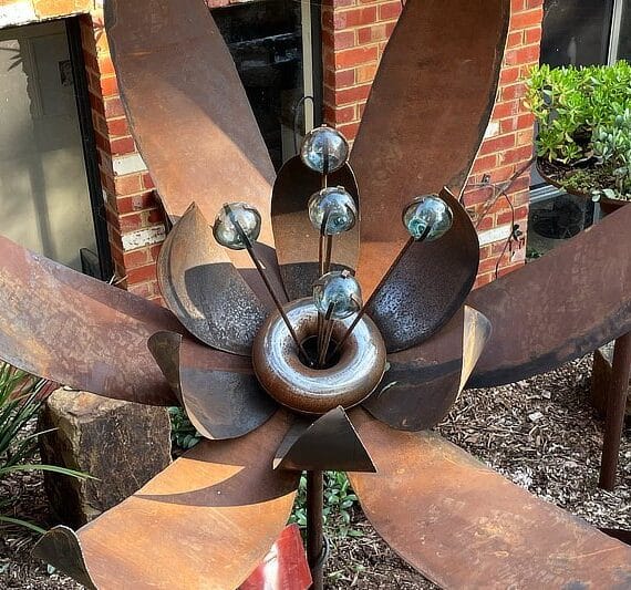 This handmade flower with its relatively low and quite flat mounting will settle beautifully into a lush garden space.