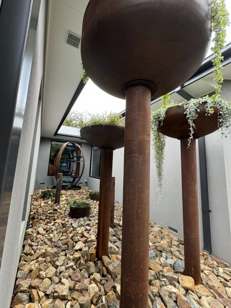 Sky gardens with a variety of plants, creating a green backdrop for the courtyard