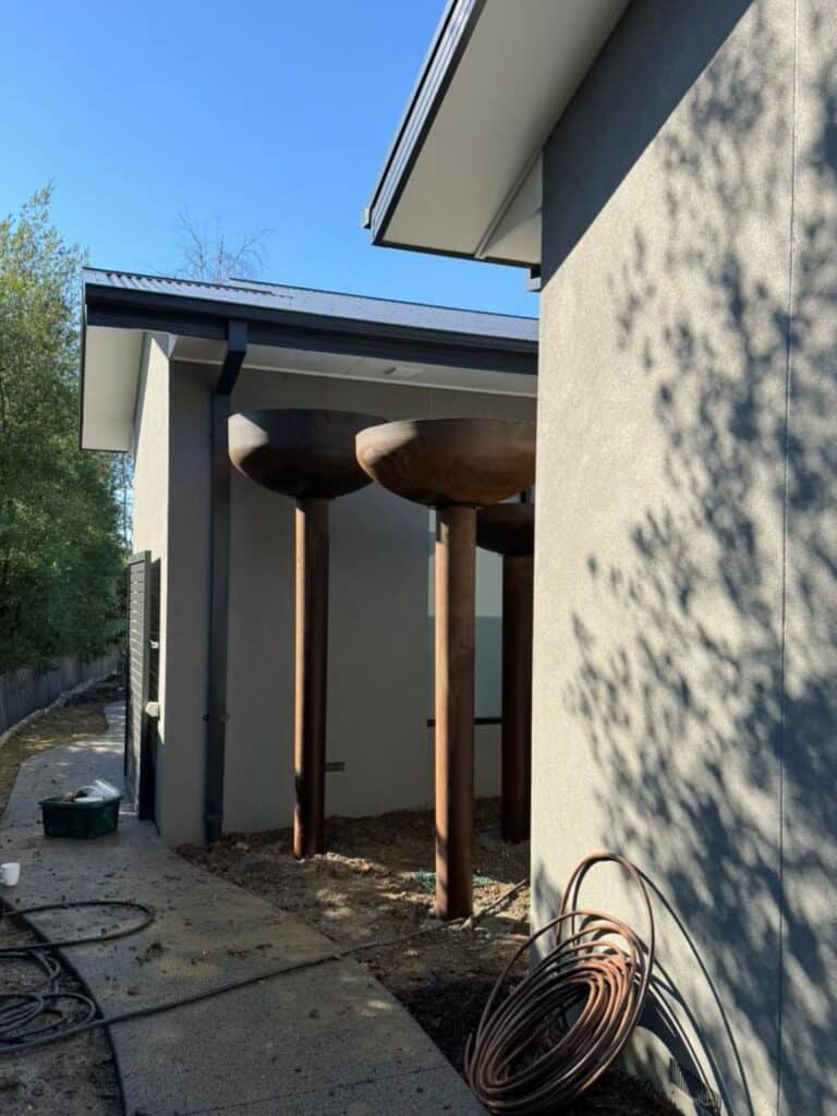 Installation of large sky gardens as a backdrop to the courtyard water feature.